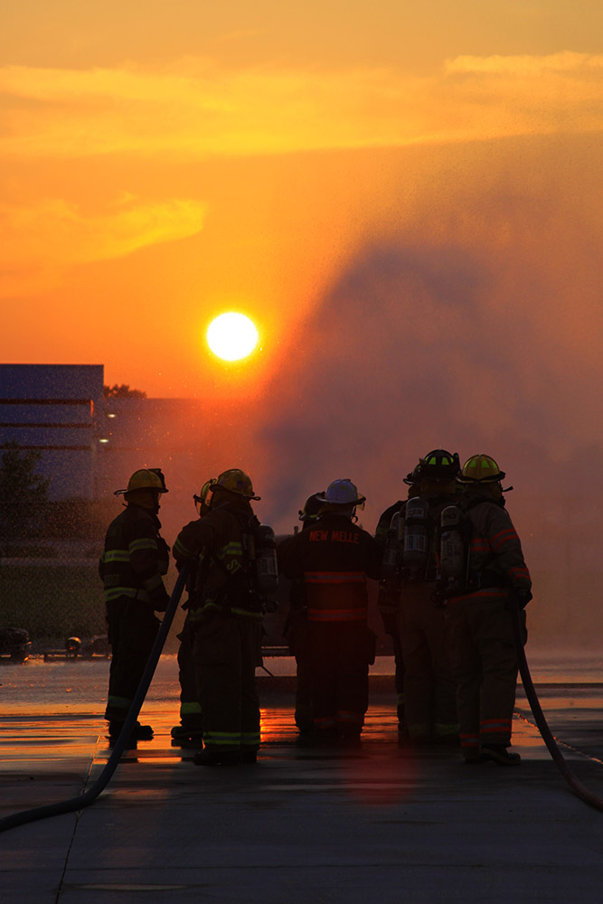 Firemen extinguishing blaze